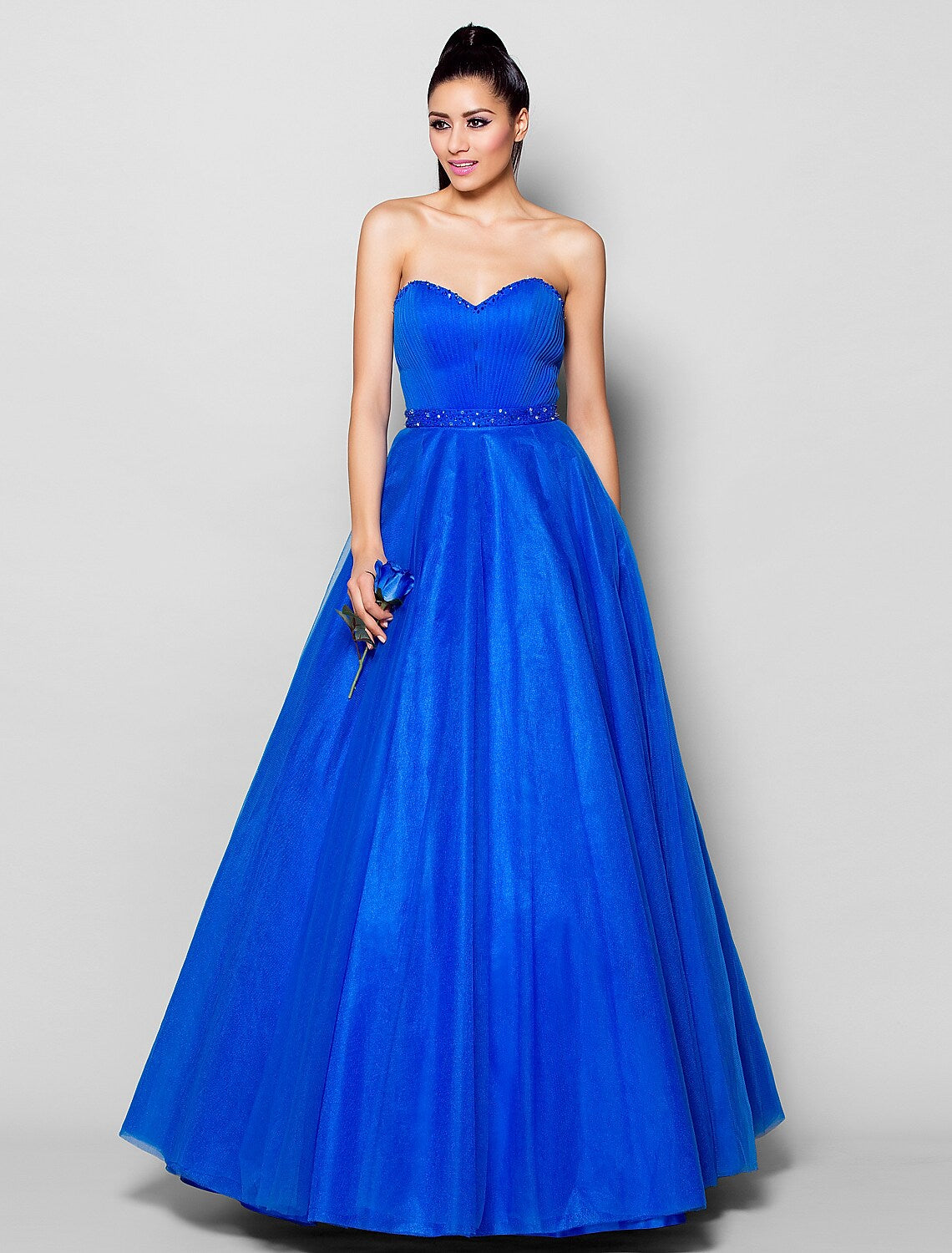 Elegant floor-length tulle ball gown with sweetheart neckline and intricate beading.