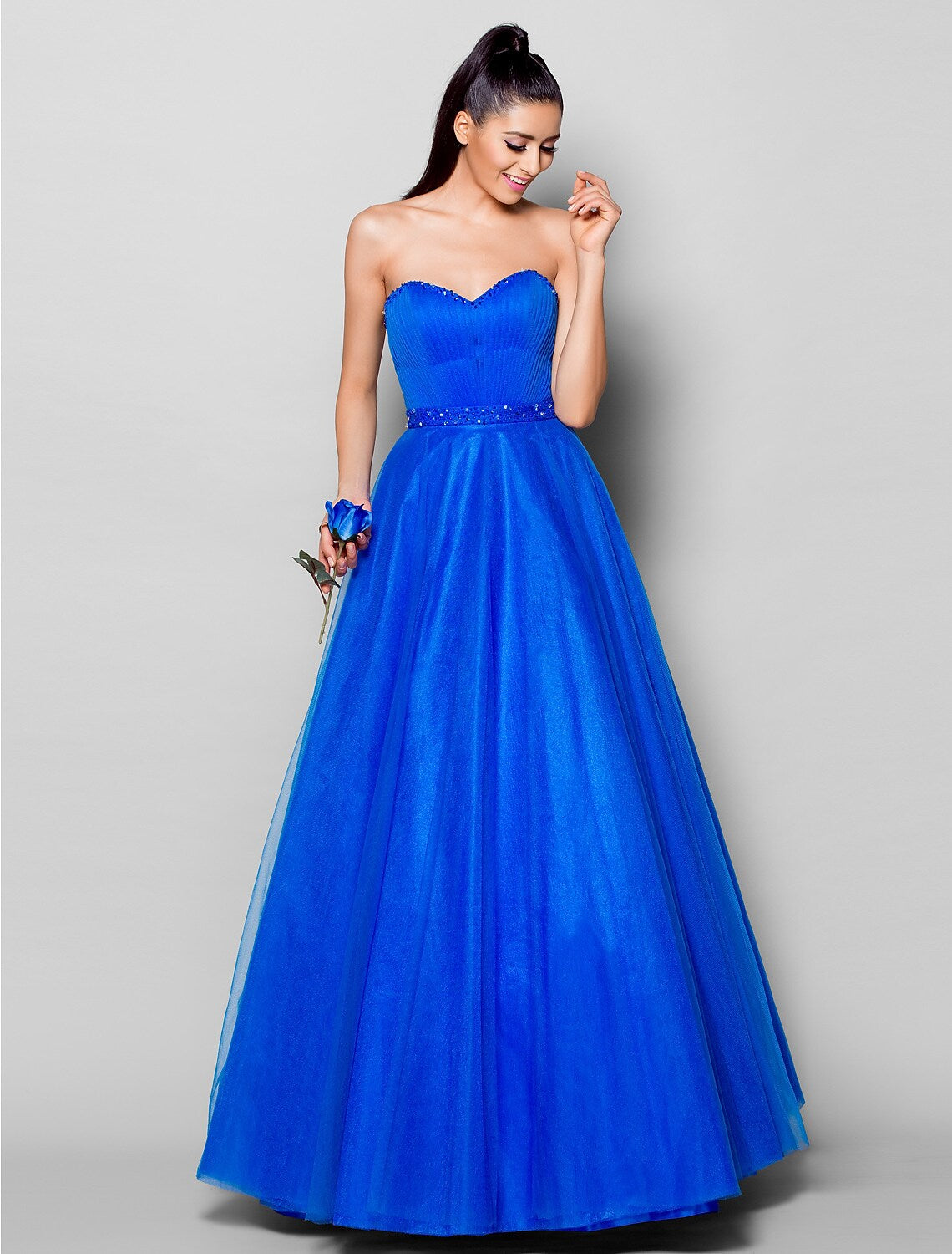 Back view of a formal lace-up ball gown, showcasing the delicate tulle and draping.