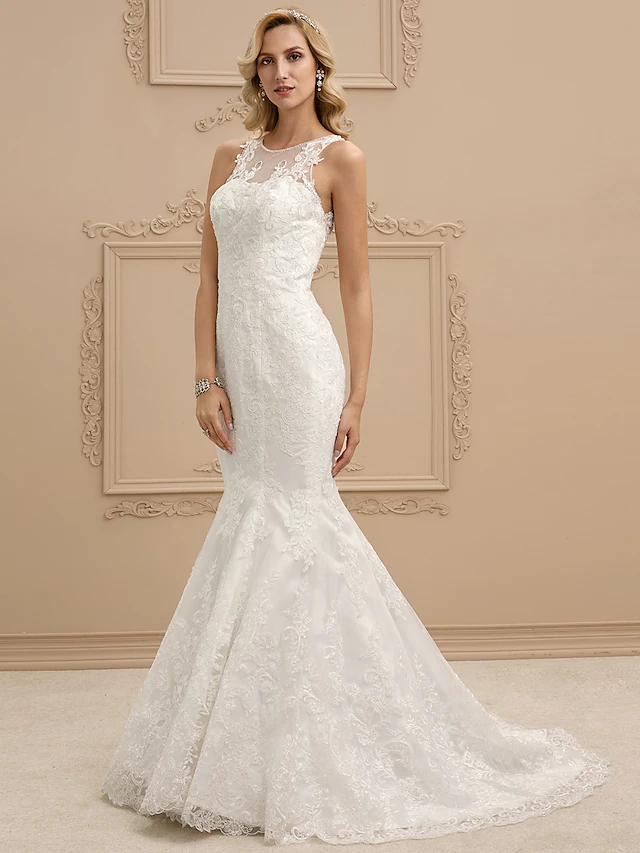 Elegant mermaid wedding dress with bateau neck and lace details.