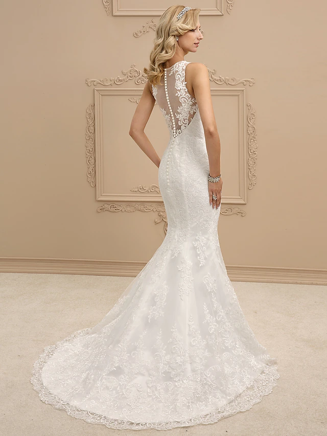 Back view of a mermaid wedding dress showing illusion detail and beading.
