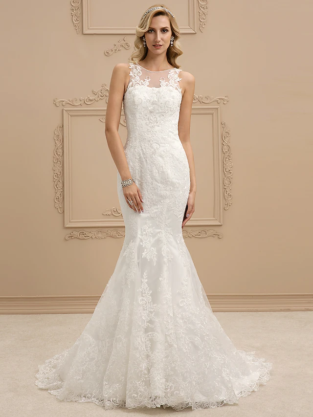 Side view of a bride in a lace mermaid wedding gown.