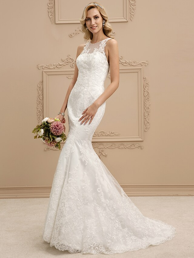 Close-up of the lace and beading on a wedding dress.