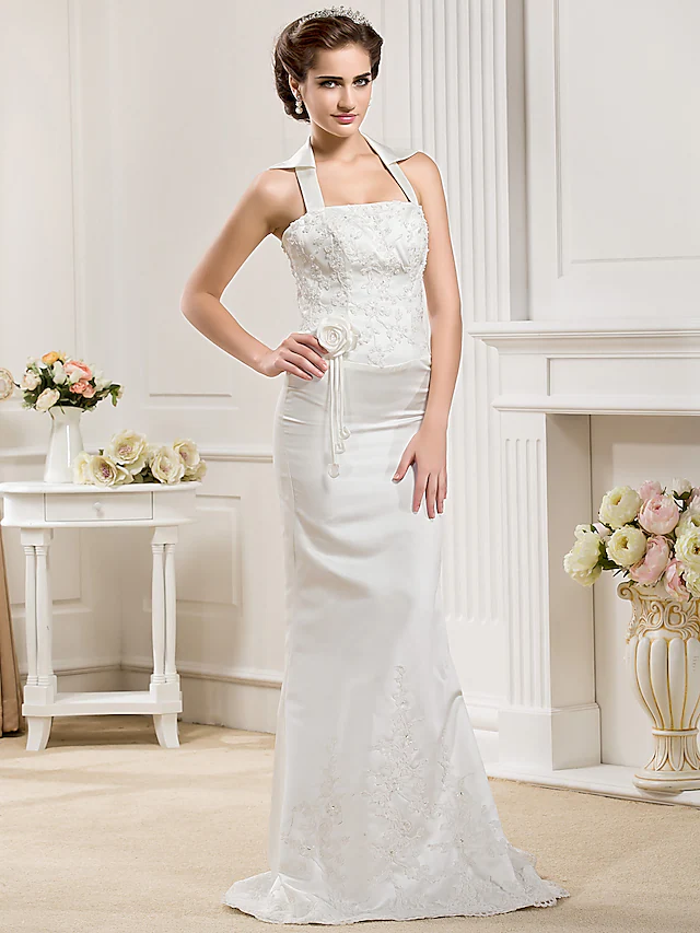 Detailed view of the satin fabric and mermaid silhouette of the wedding dress.