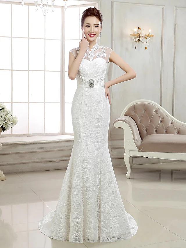 Elegant mermaid wedding dress with high neck, lace cap sleeves, and beaded appliques.