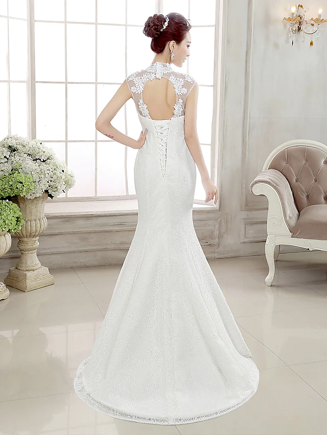 Back view of mermaid wedding dress showing illusion detail and backless design.