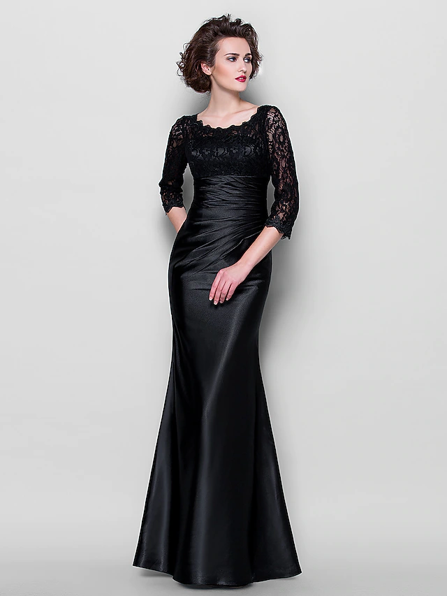 Close-up of the jewel neckline and lace overlay on the dress.