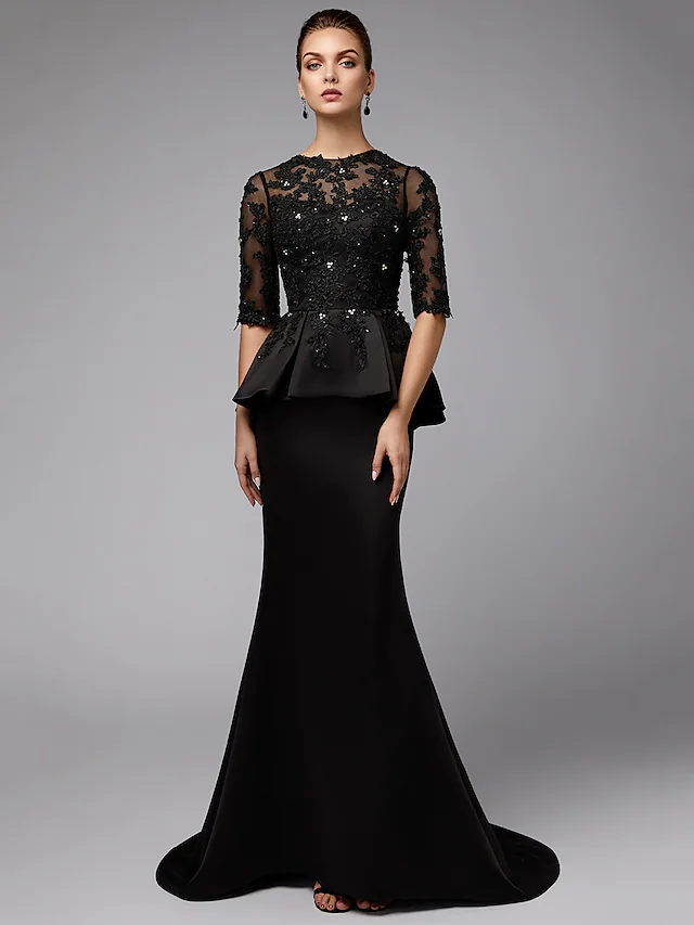 Close-up of jewel neck and half sleeves with lace and beading details on navy dress.