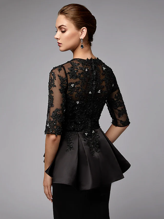 Close-up of the mermaid skirt and beaded appliques on the navy dress.