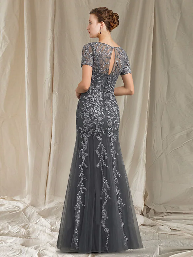 Back view of an elegant mermaid mother of the bride dress with lace and tulle details.