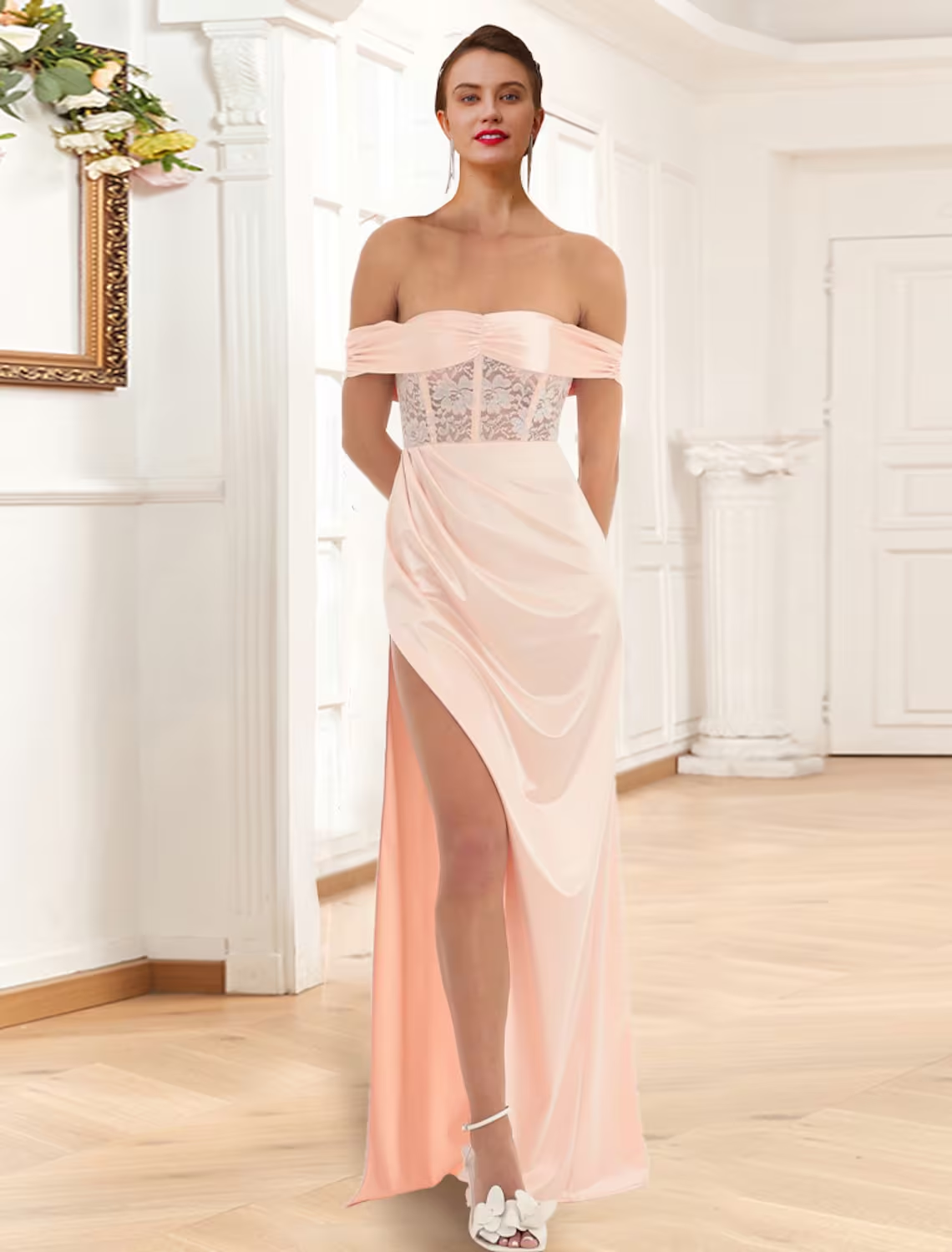 Woman wearing an elegant off-shoulder mermaid prom dress with lace details and a side slit.