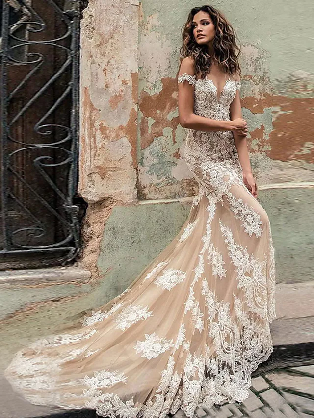 Back view of a mermaid off-shoulder lace wedding dress with a long court train.