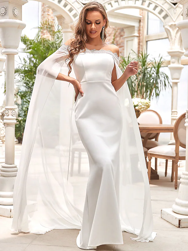 Elegant white off-shoulder mermaid wedding dress with draping and lace details.