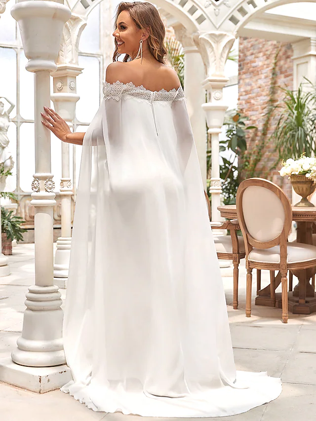 Back view of a white off-shoulder mermaid wedding dress with a sweep train.