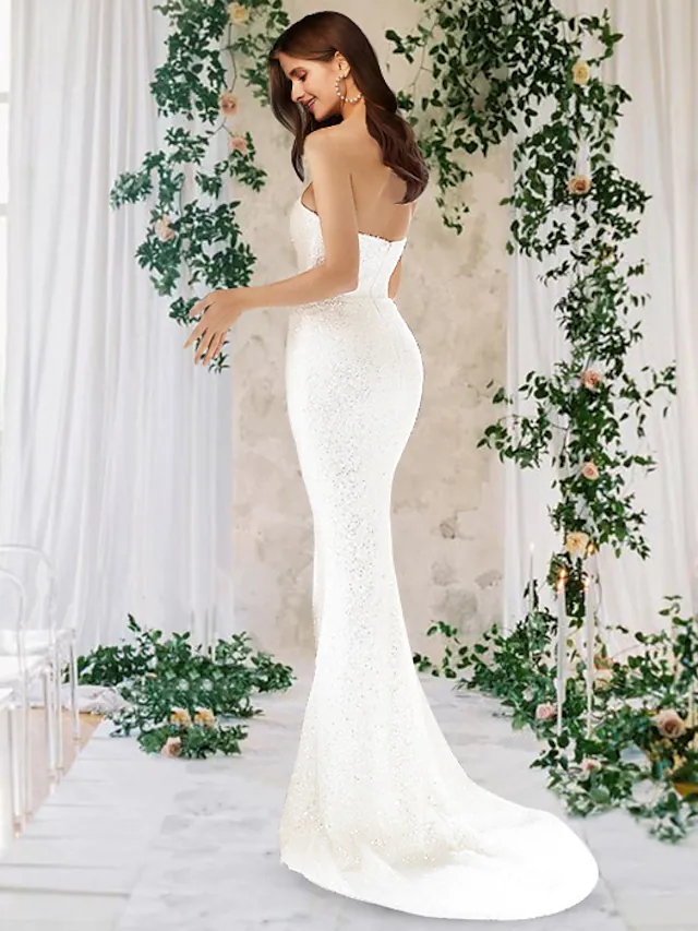 Back view of the sequined one-shoulder wedding gown.