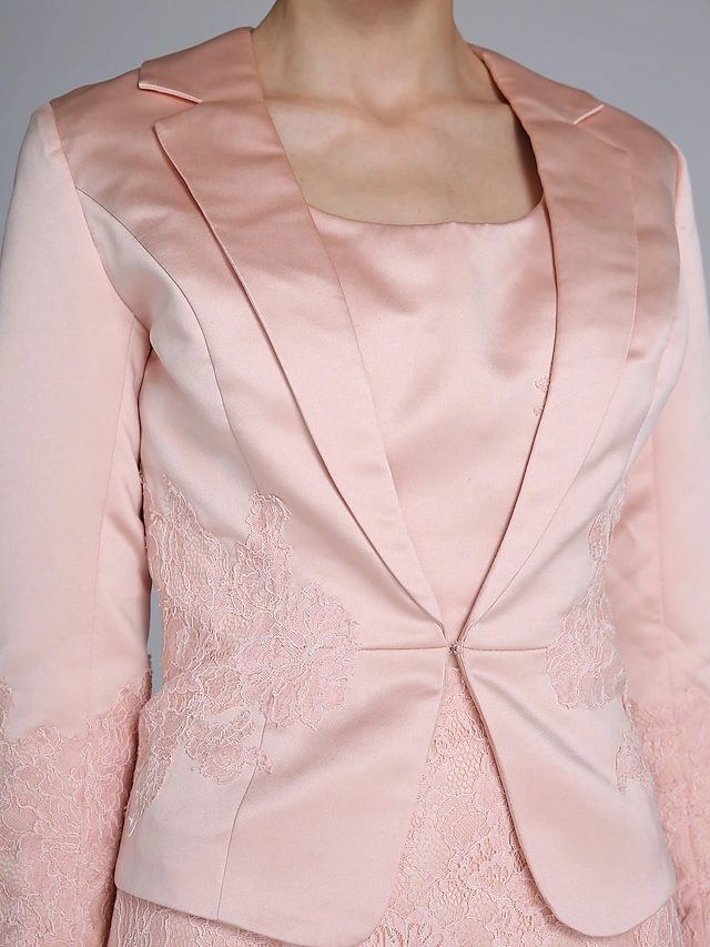 Detail of the long lace sleeve on the elegant satin dress.