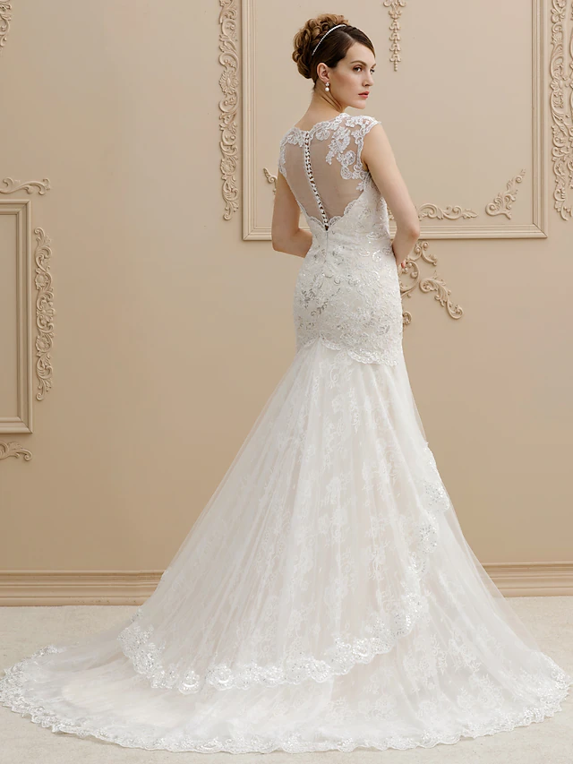 Back view of a mermaid wedding dress showing a court train and sequin appliques.