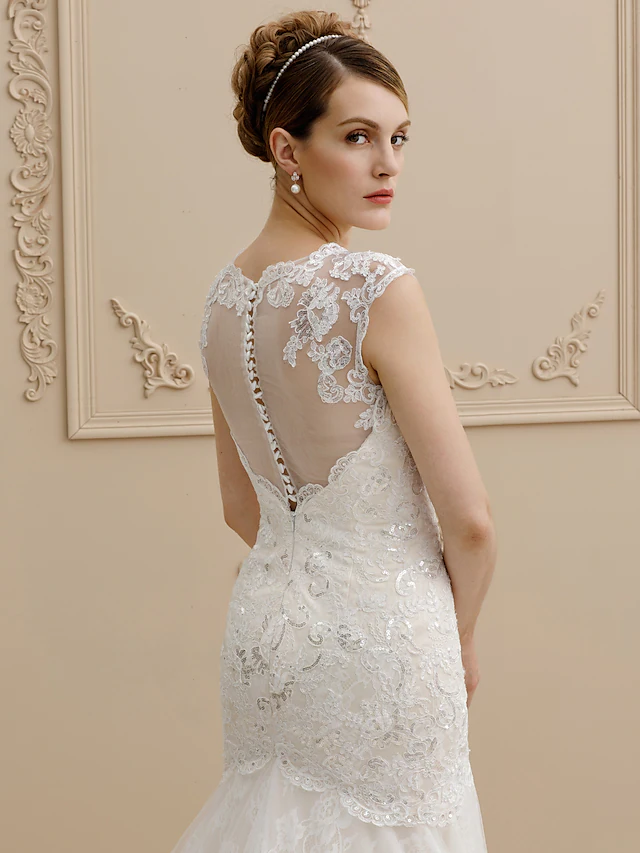 Full length view of a mermaid wedding dress with sparkling sequin embellishments.