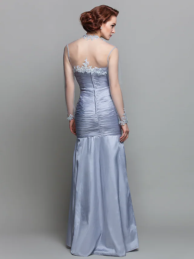 Back view of the mermaid Mother of the Bride dress, showcasing the floor-length silhouette and intricate appliques.