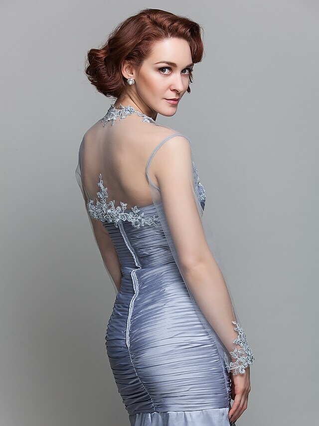 Mother of the Bride dress with a flowing mermaid skirt and elegant train.