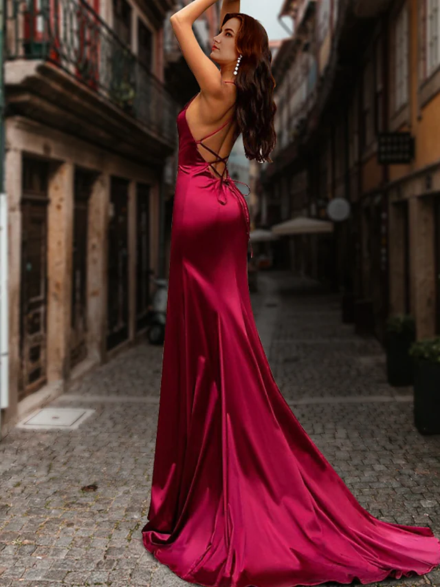 Close-up of a red satin mermaid dress, highlighting its luxurious fabric and form-fitting style.