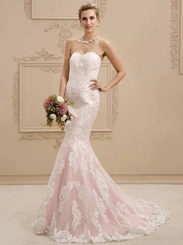 Close-up of lace appliques and illusion detail on the wedding dress bodice.