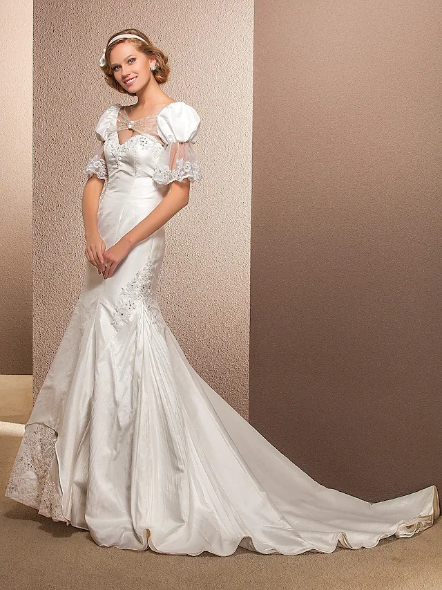 Side profile of a sleeveless bridal gown.