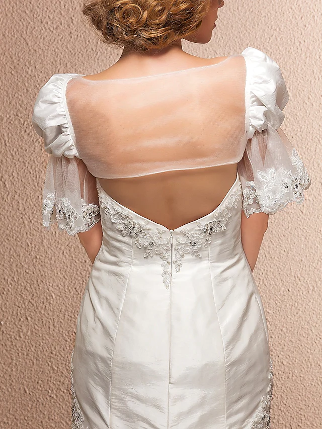 Flowing silhouette of a taffeta wedding dress.