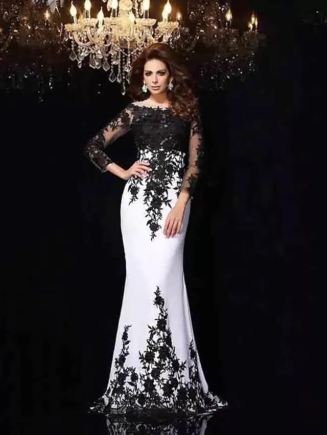 Elegant black mermaid trumpet wedding dress with bateau neck and long illusion lace sleeves.
