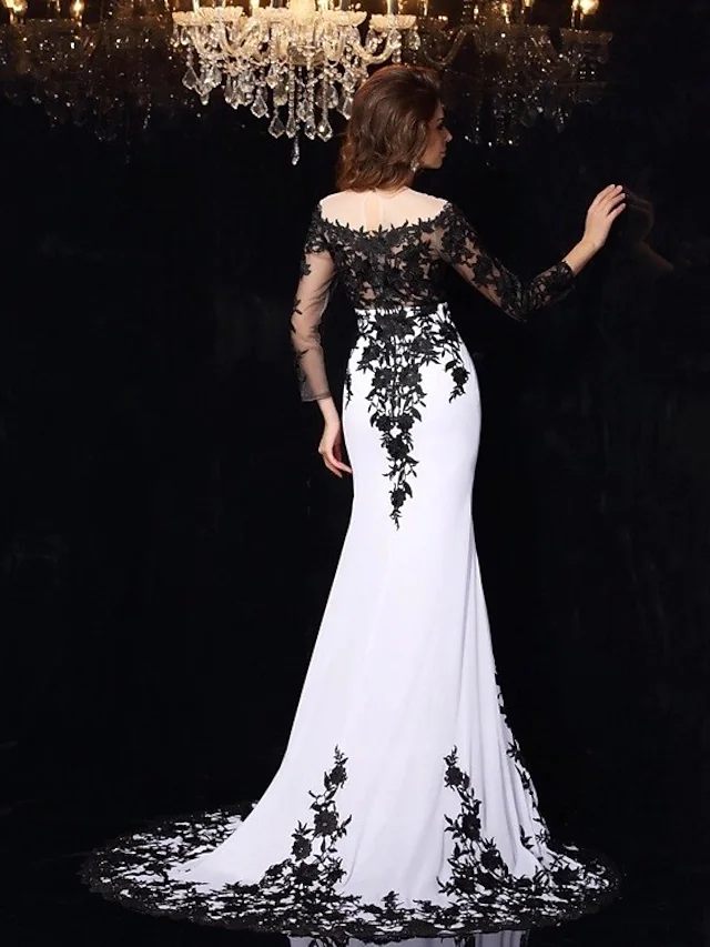 Close-up of the black lace and applique details on the wedding dress sleeve.
