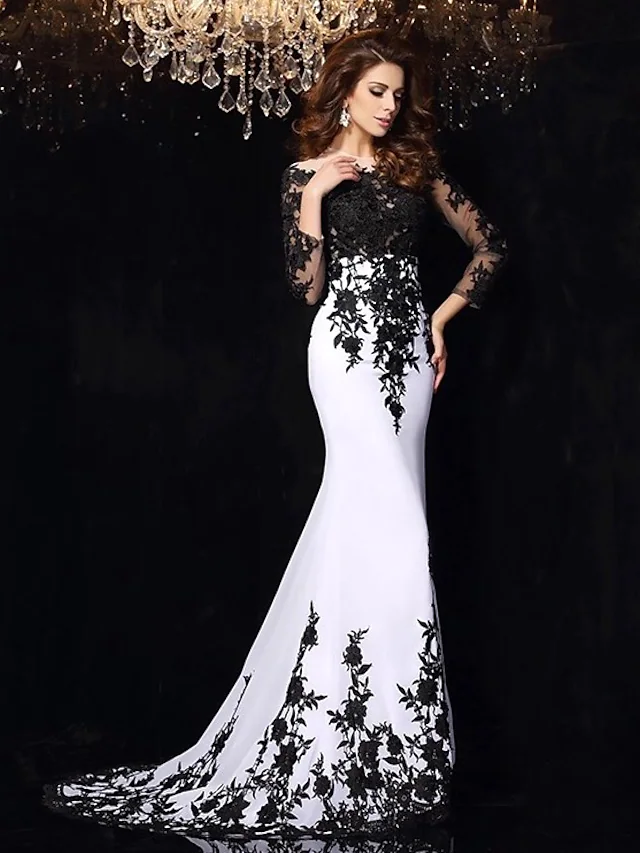 Back view of the black wedding dress showcasing the long illusion sleeves and train.