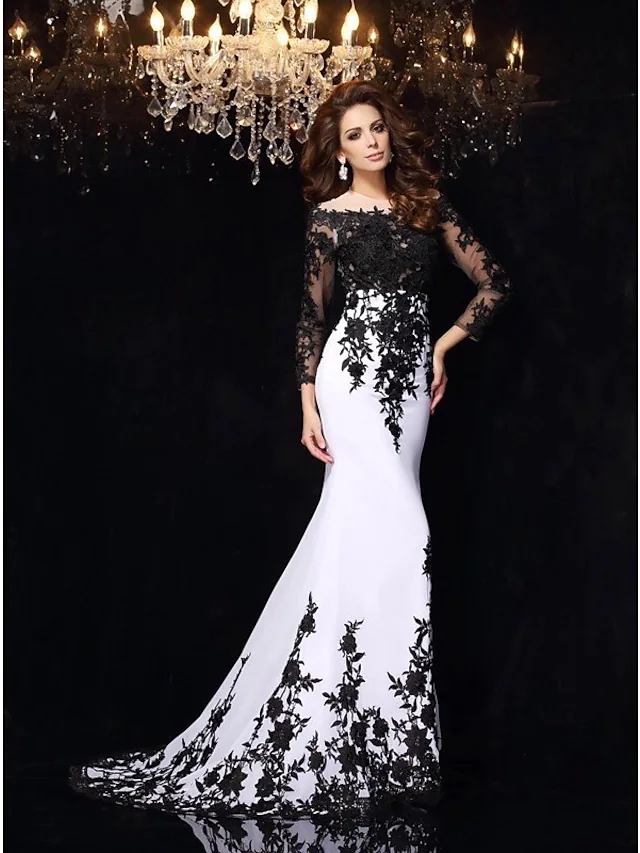 Detailed view of the black lace appliques on the bodice of the wedding dress.