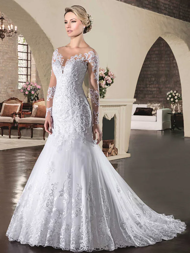 Back view of the wedding dress showcasing the see-through backless design and court train.