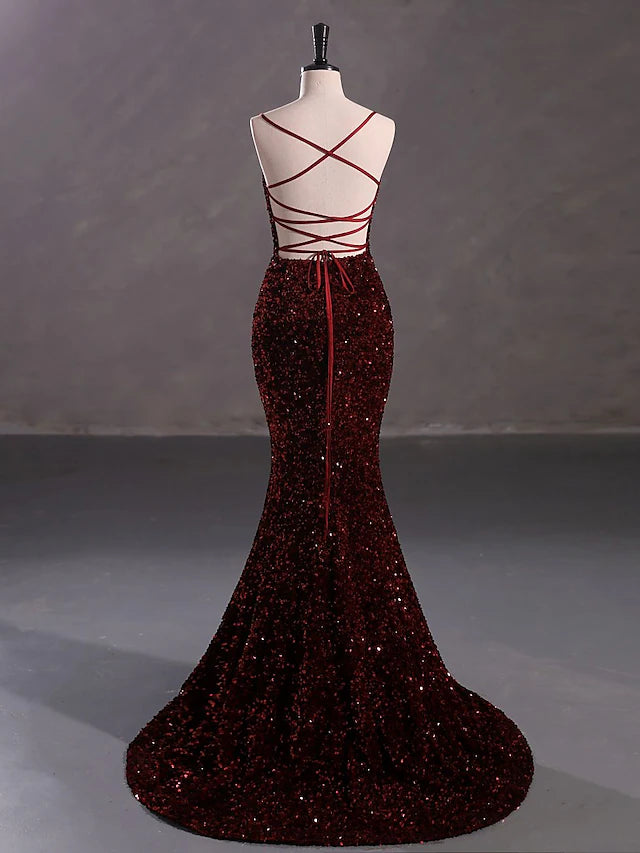 Woman posing in a stunning Mermaid Trumpet evening gown.
