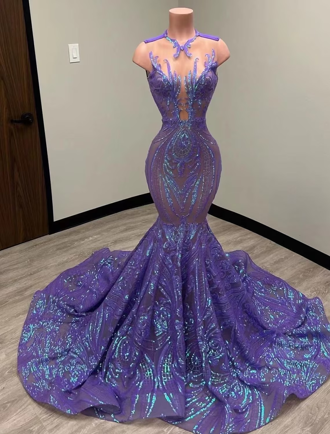 Close-up of the sequined fabric and illusion neckline on a mermaid gown.