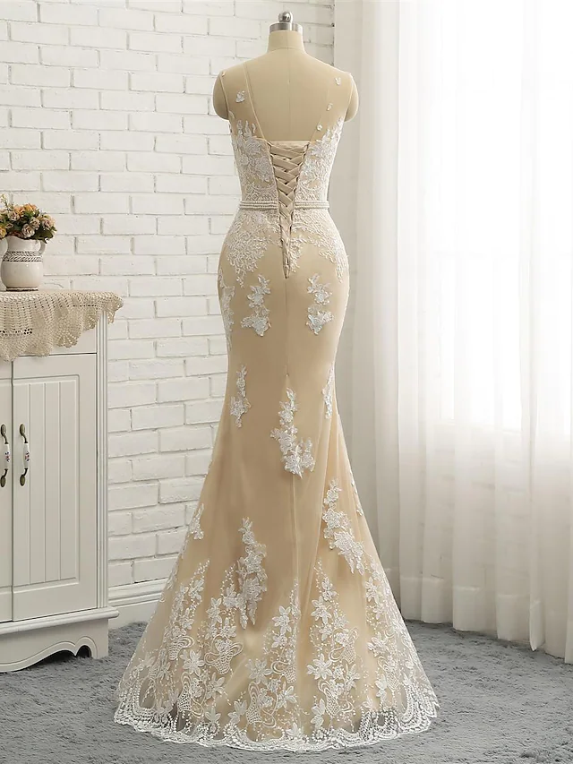 Bride posing in a formal wedding dress with sashes and ribbons.