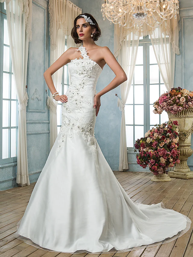 Elegant one-shoulder mermaid wedding dress with beading and court train, front view.