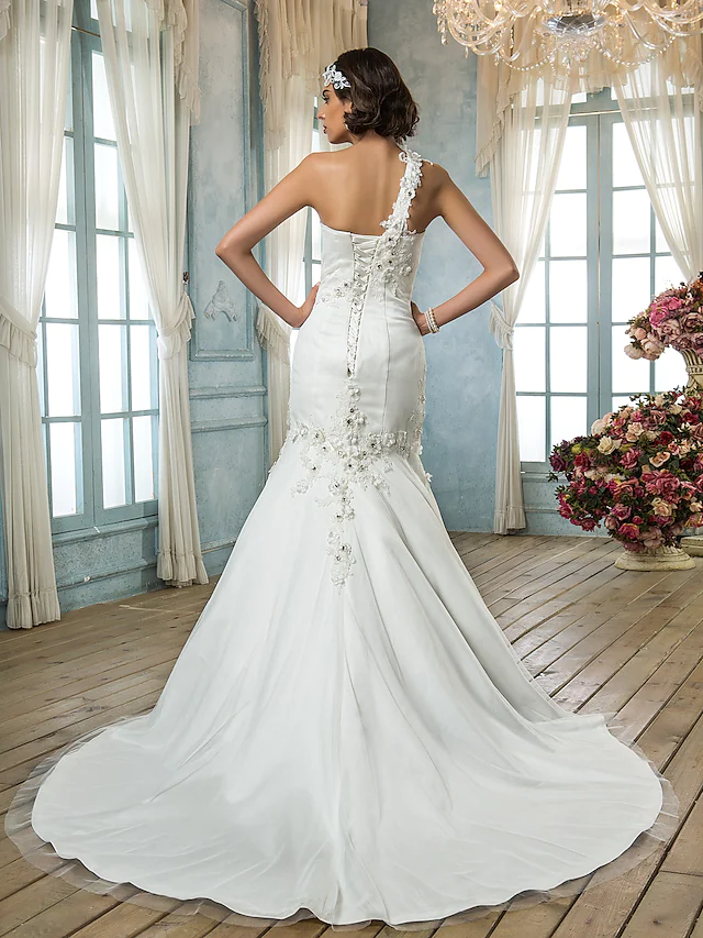 Side view of a mermaid wedding gown, showcasing the court train and appliques.