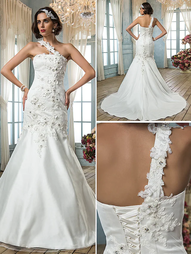 Back view of the one-shoulder bridal gown, highlighting the train and delicate details.