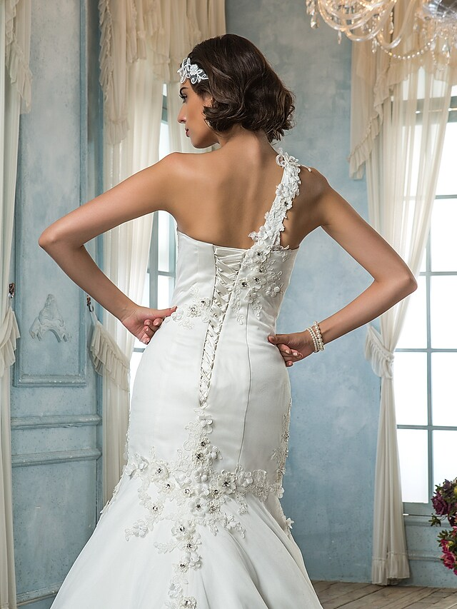 Mermaid trumpet wedding dress from a three-quarter angle, showing silhouette.