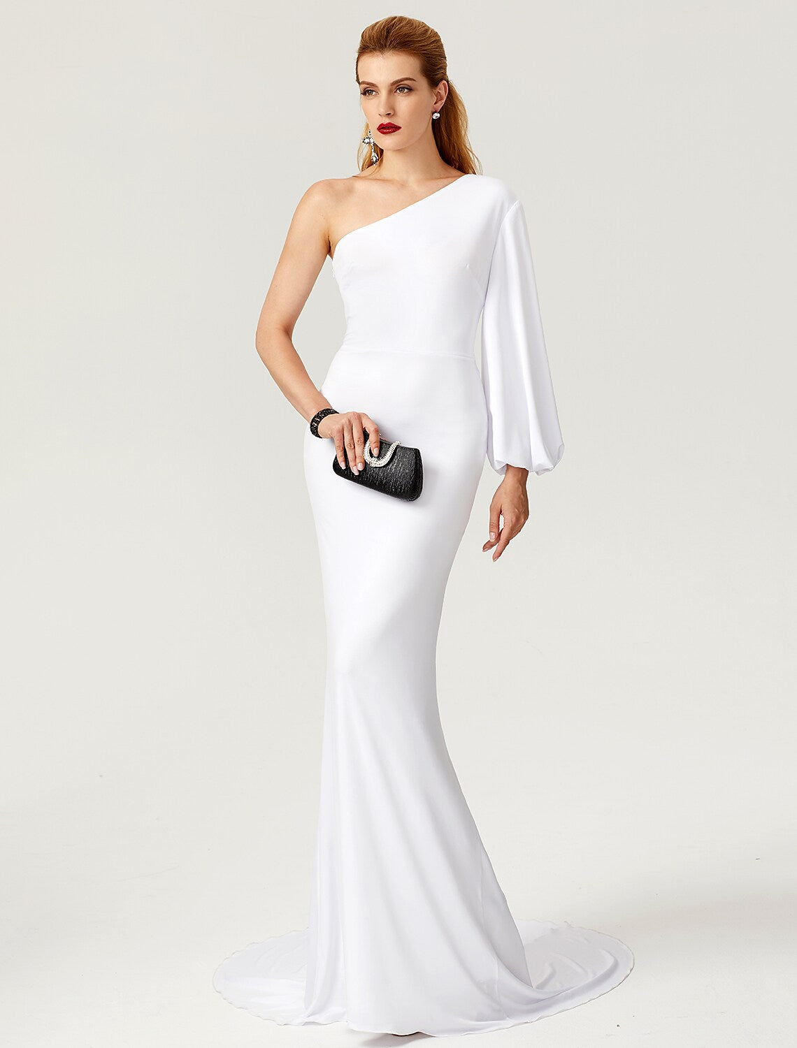 Close-up of the pleated detail on the elegant one-shoulder long-sleeve mermaid gown.