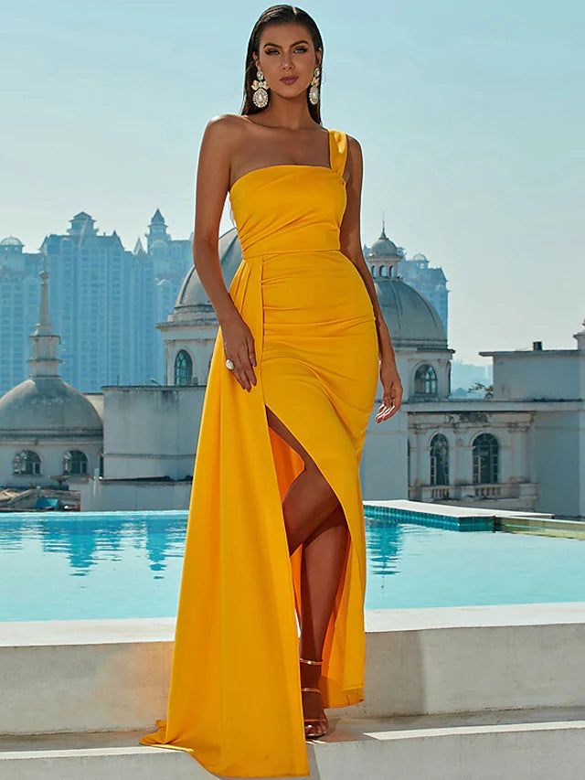 Model wearing a one-shoulder mermaid trumpet evening gown with a ruched slit.