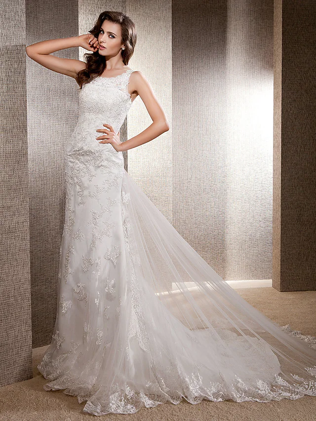 Side profile of a bride wearing a lace and tulle mermaid wedding gown.