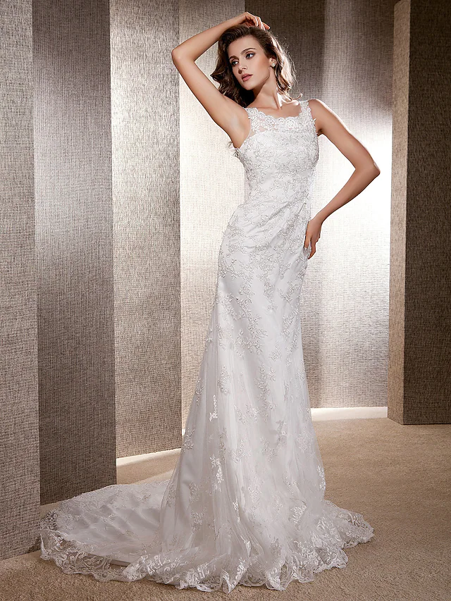 Close-up of the lace detail on the bodice of a scoop neck wedding dress.
