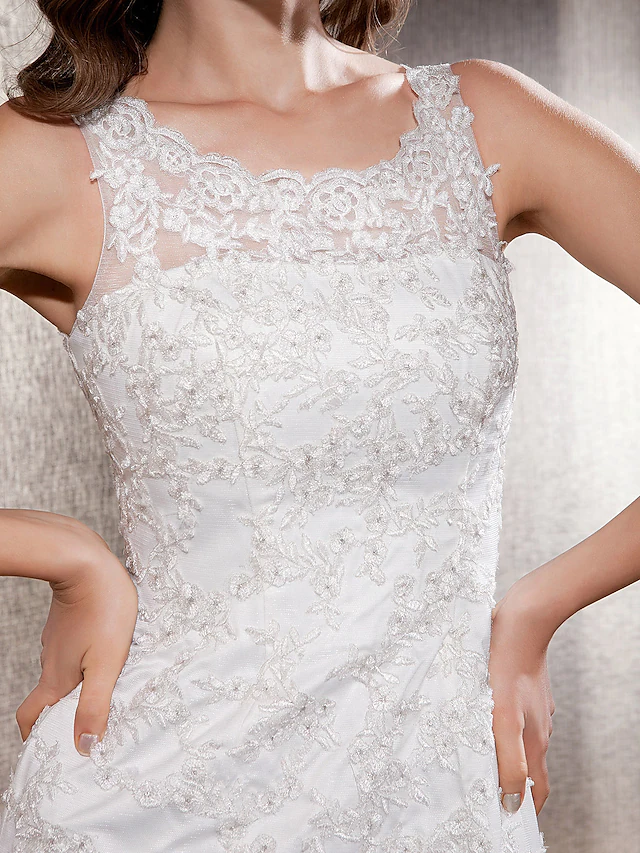 Mermaid trumpet wedding dress showcasing the tulle skirt and sweep train.