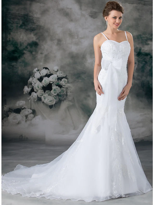 Close-up of the sweetheart neckline and beaded lace on a wedding dress.
