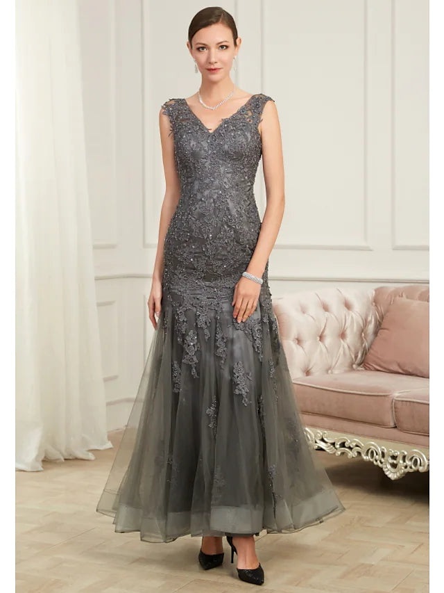 Woman wearing an elegant V-neck mermaid evening gown with sequin appliques.
