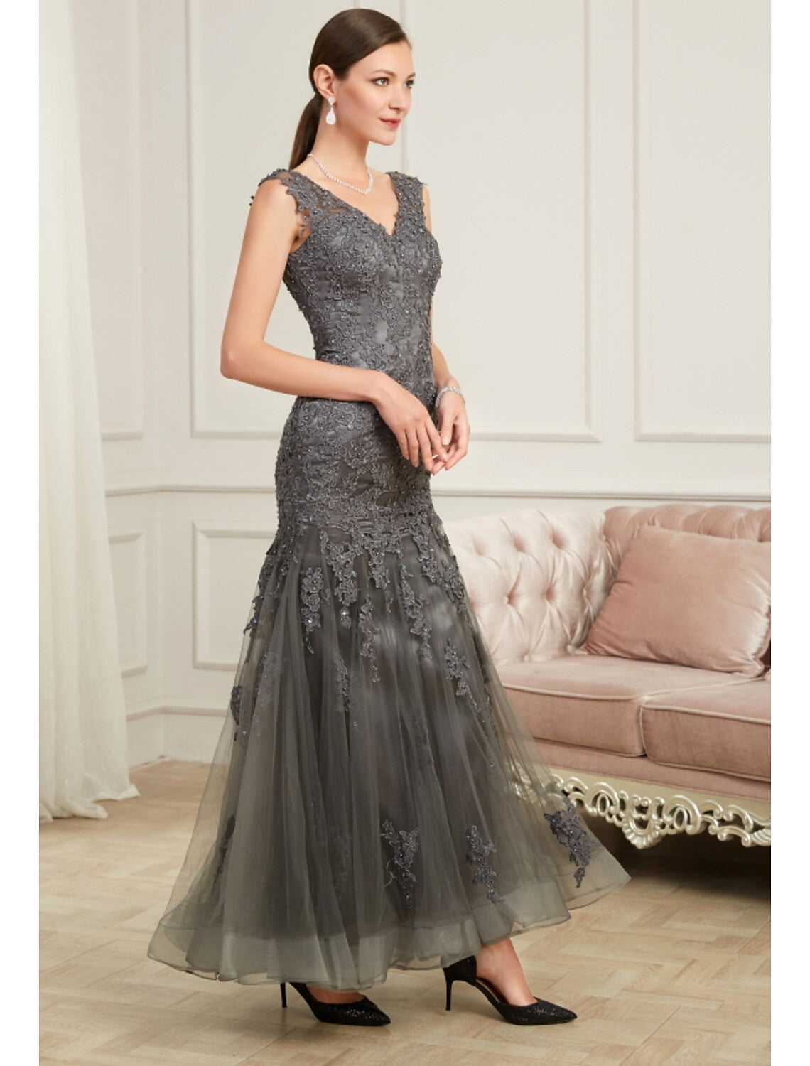 Close-up of sequin appliques and V-neckline on the elegant mermaid gown.