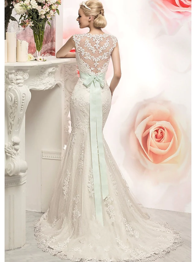 Back view of the Mermaid Trumpet wedding dress showing court train and lace appliques.