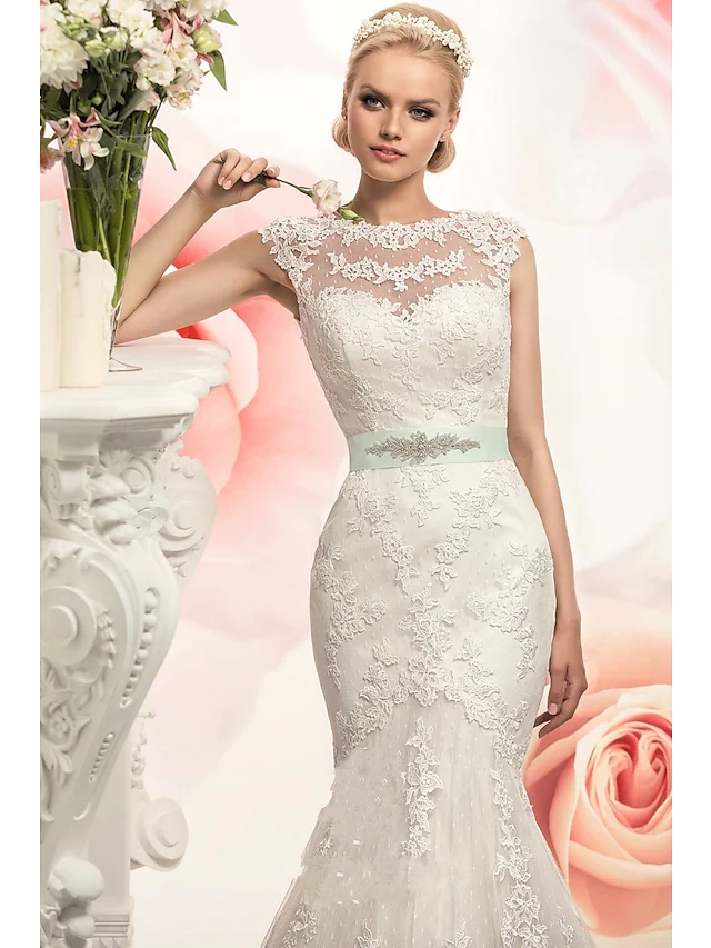 Close-up of lace and applique details on the wedding dress.
