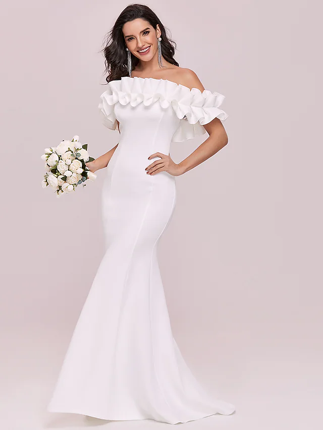 Close-up of the stretch fabric and ruffle details on a wedding dress.